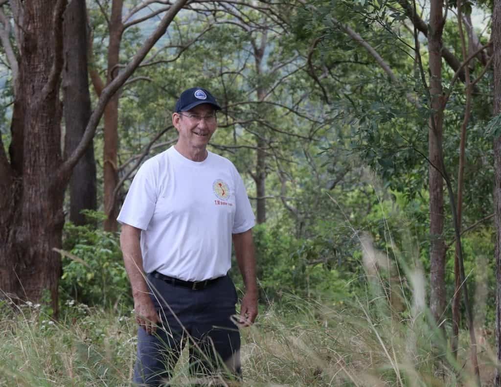 Jim Kinkead, President of Tregeagle Landcare Group, stands in a bush setting.