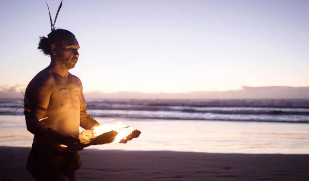 Aboriginal man Nathan Brennan on the beach at dusk