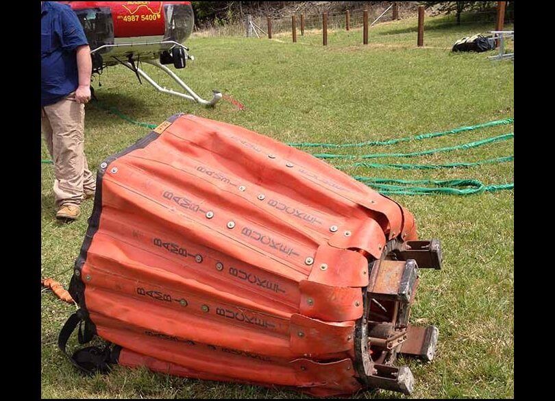 Bambi bucket a collapsible bucket utilizing a pilot controlled valve that can deliver a concentrated column of water from the helicopter to the fire for use in fire combat