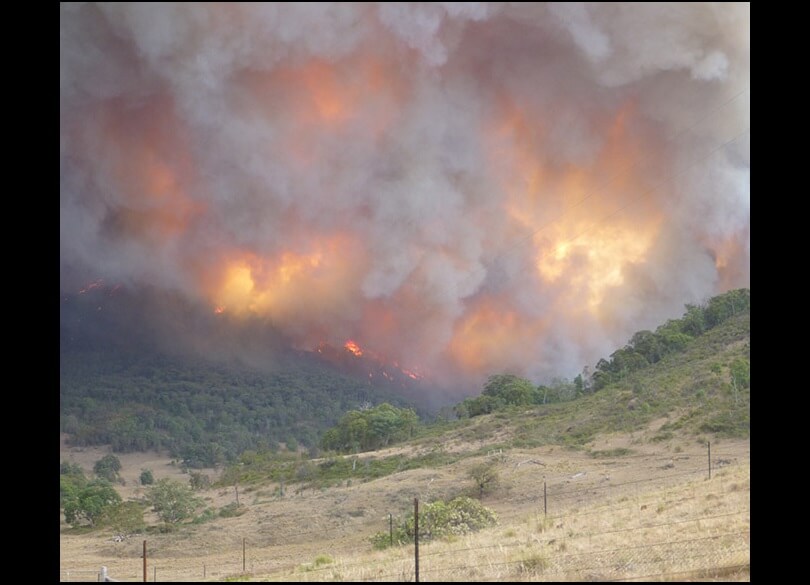 Red sky fire light and smoke plume over paddock from Wambelong fire