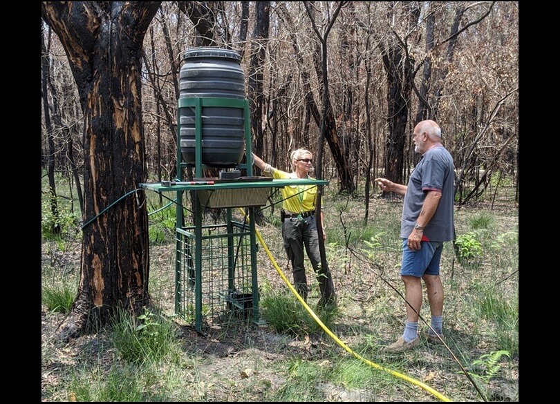 NPWS ranger Libby Jude and Koala Hospital staff member Steve Withnall installing a koala/wildlife drinking station at Crowdy Bay National Park