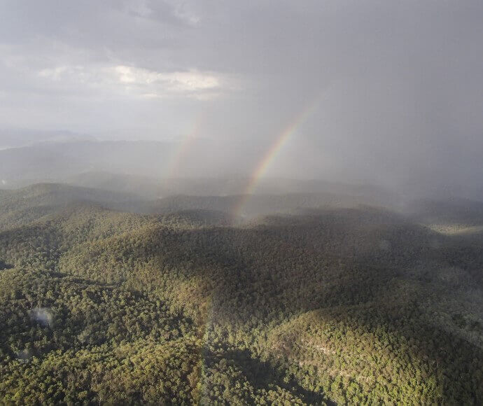 A rainbow appears out of a bushfire in the lower Hunter area