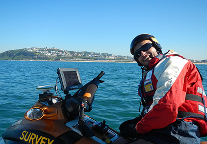 Scientist completing a hydrographic survey using a jet-ski mounted single-beam echosounder at Mereweather Beach, Newcastle.