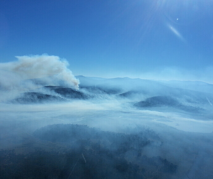 Smoke at sunrise with clouds and early morning mist viewed from helicopter. Denison Providence hazard reduction burn