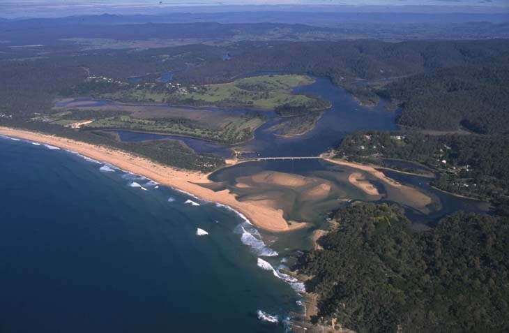 A view of the Bega River entering the ocean at Mogareeka Inlet with Tathra Beach in the foreground