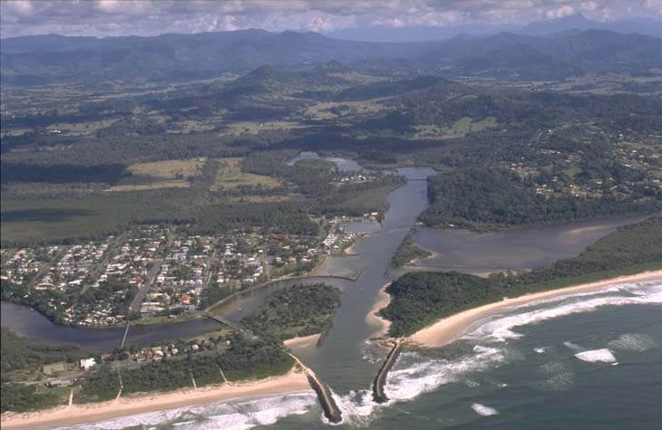 A view of Brunswick River meeting the sea surrounded by wetlands and next to the town of Brunswick Heads