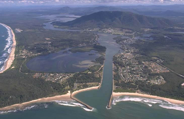 A view of Camden Haven River meeting the sea through Camden Haven Inlet flanked by Pilot Beach and North Haven Beach