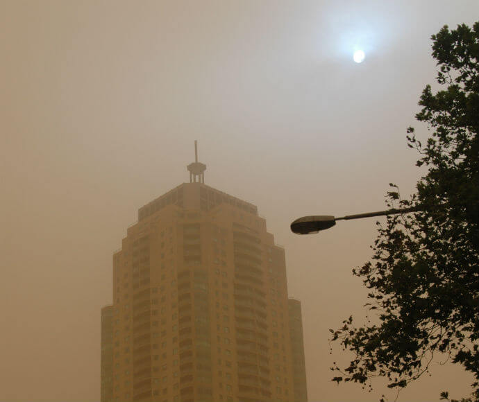 Thick dust obscures the sun and buildings in Sydney.