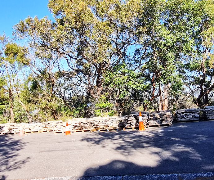 A section of the new outer sandstone wall in front of the concrete blockwork wall.