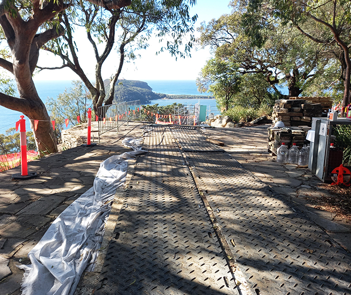 An overview of the protection measures implemented at West Head Lookout, showcasing safety barriers and natural landscaping designed to preserve the area while providing scenic views of the surrounding landscape.