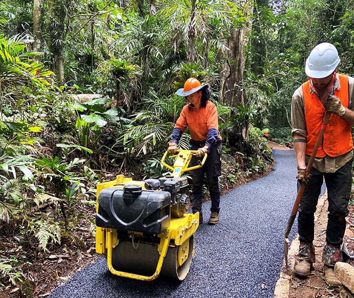 Two workers resealing the track