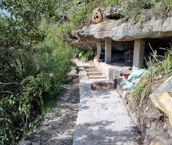 Path on side of hill being repaired; stone and foliage; Wattamolla Beach Track