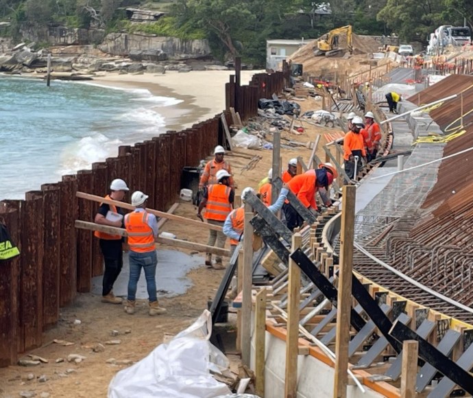 The first bleacher concrete pour, Nielsen Park, 7 March 2024, with workers in orange high-vis vests and white hardhats