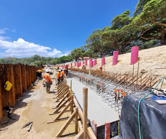 Workers with newly poured concrete at Neilsen Park seawall