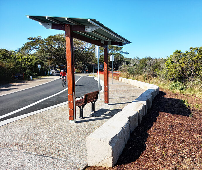 Bus stop at North Head, Sydney Harbour National Park, surrounded by lush greenery and scenic views.