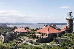 Photo of Barrenjoey headland with proposed new amenities outlined by dotted white line. The illustration shows the layout of the amenities in relation to the surrounding landscape, highlighting the integration of the structure within the natural environment.